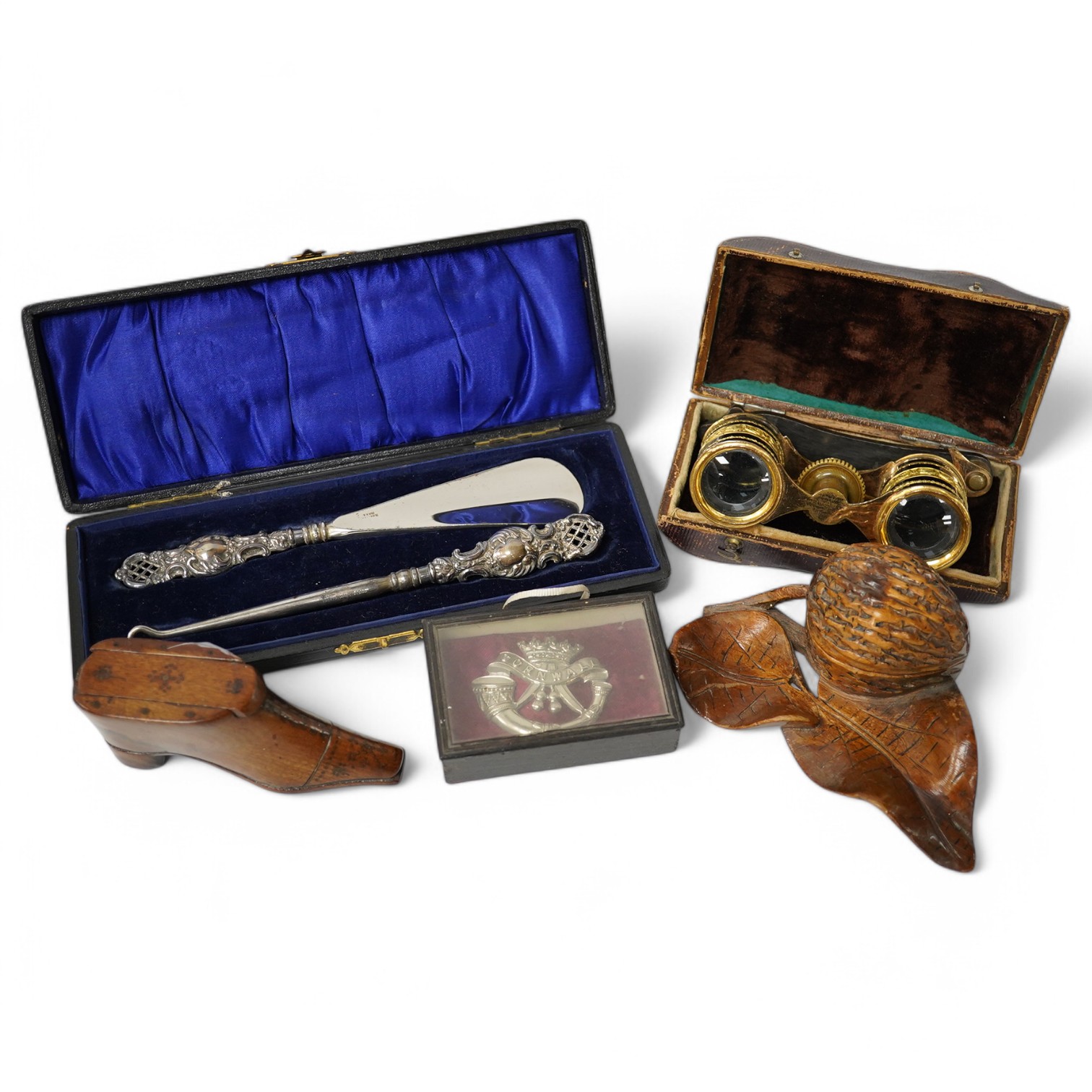 A pair of French opera glasses in case (a.f.), a wooden snuff-shoe, a carved wood walnut inkwell, a 